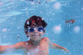 Kid swimming underwater 